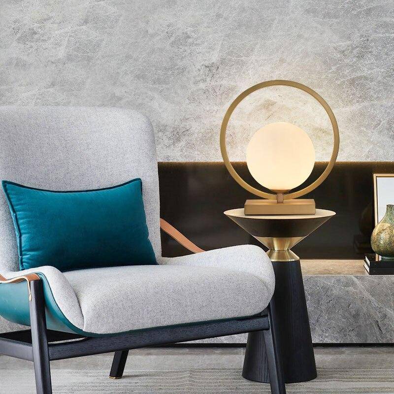 Designer LED table lamp with gold circle and glass globe