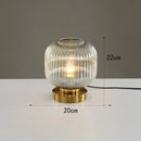Cylindrical table lamp in coloured glass with gold base Quinn