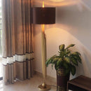 Golden design floor lamp with rounded black lampshade body