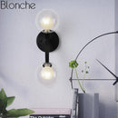 Modern gold wall sconce with glass globe