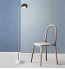 Elegant gold floor lamp with black globe shade and marble base