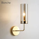 Cylindrical glass wall light with gold base