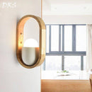 Rounded wooden wall light with interior studio lamp